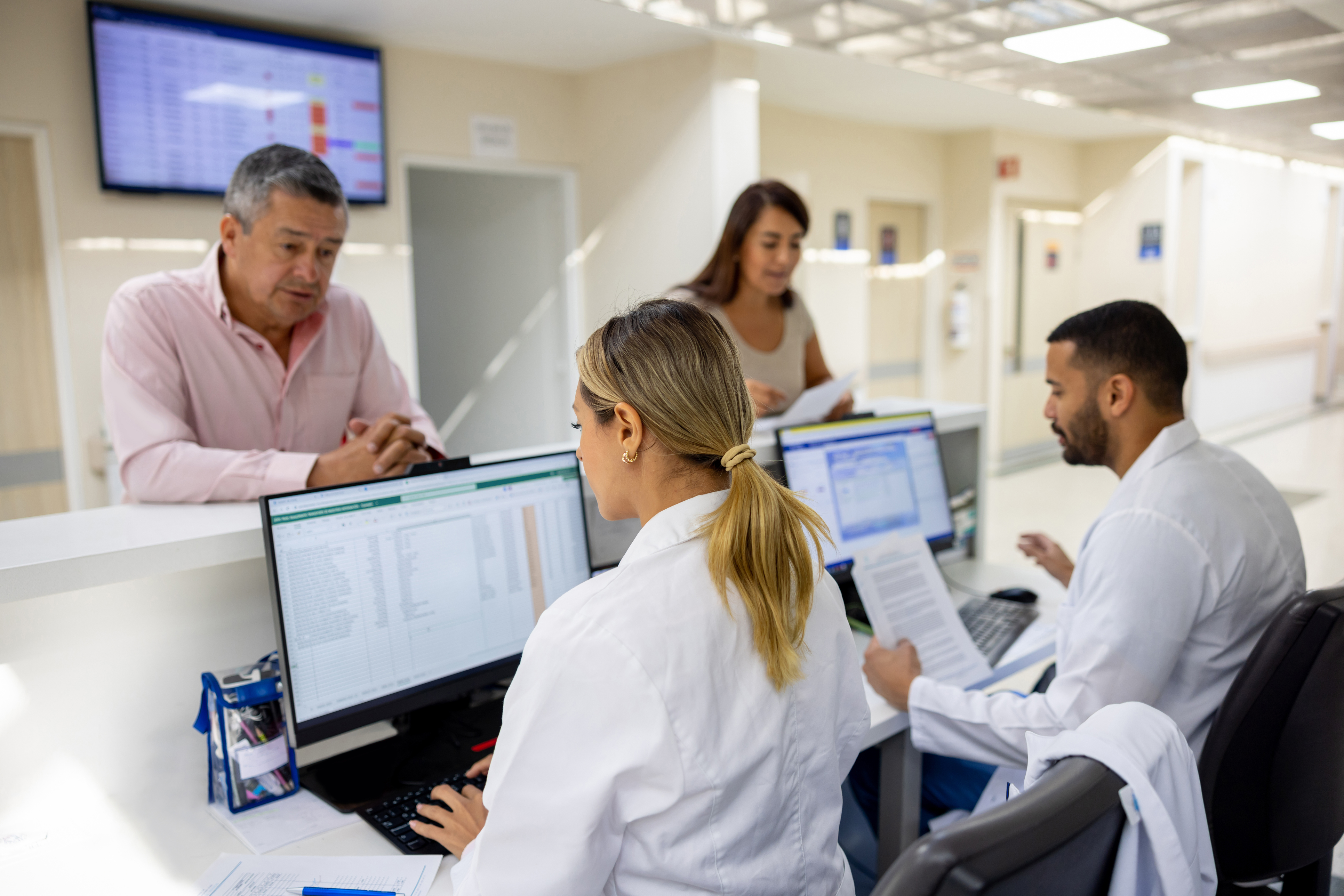 Medical Assistants checking in patients -1501183871 two medical assistants checking in patients