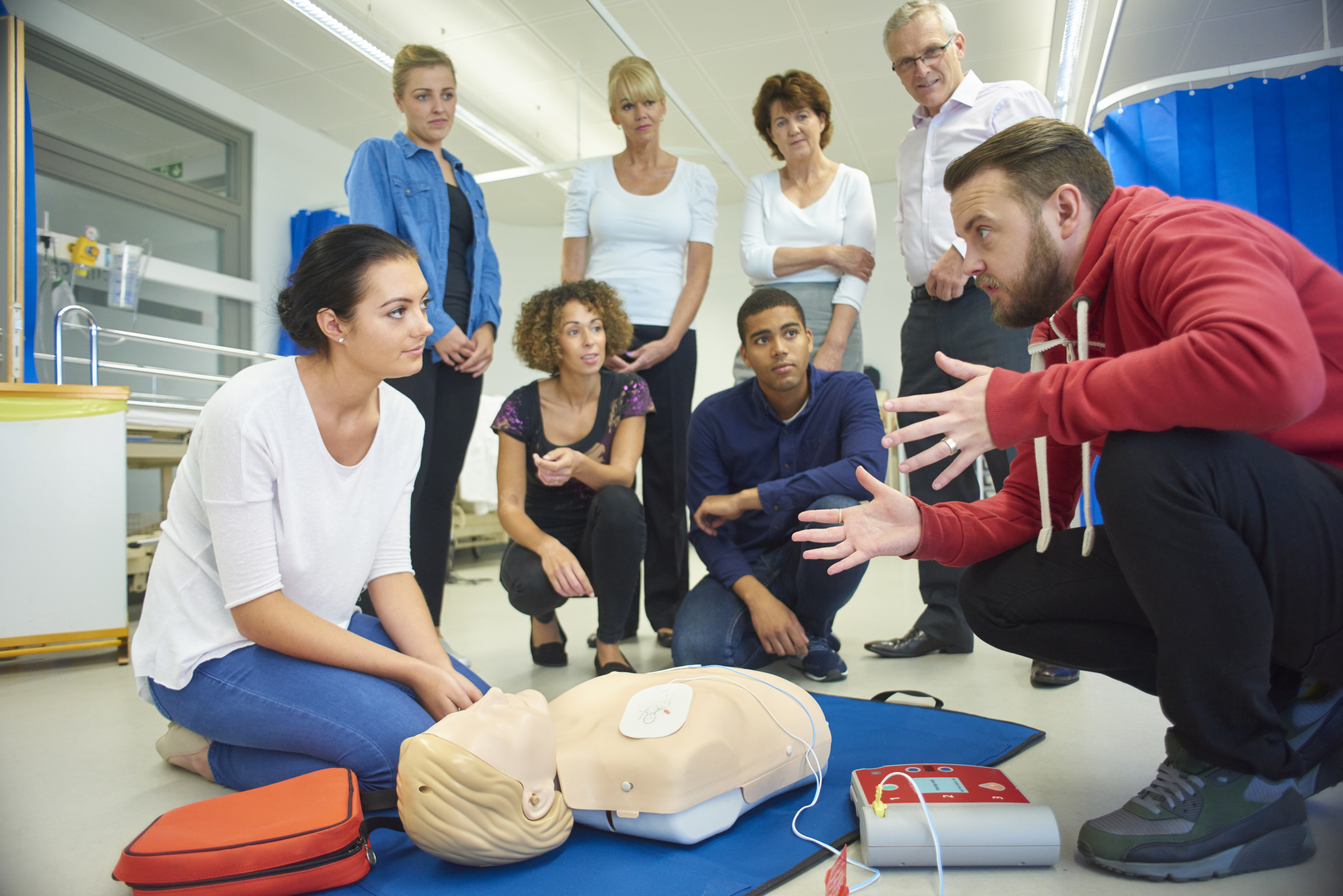 iStock-619263856 group of men and women taking a CPR class