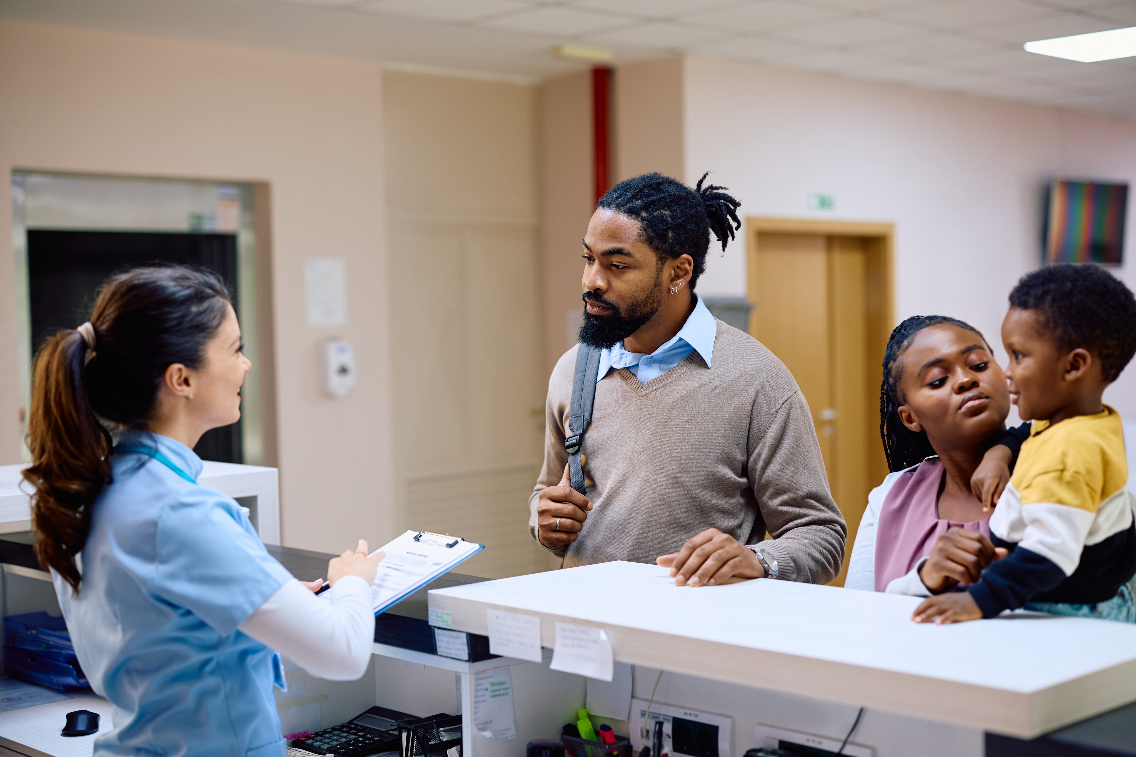 iStock-1499159939 Medical Assistant Checking in a Family