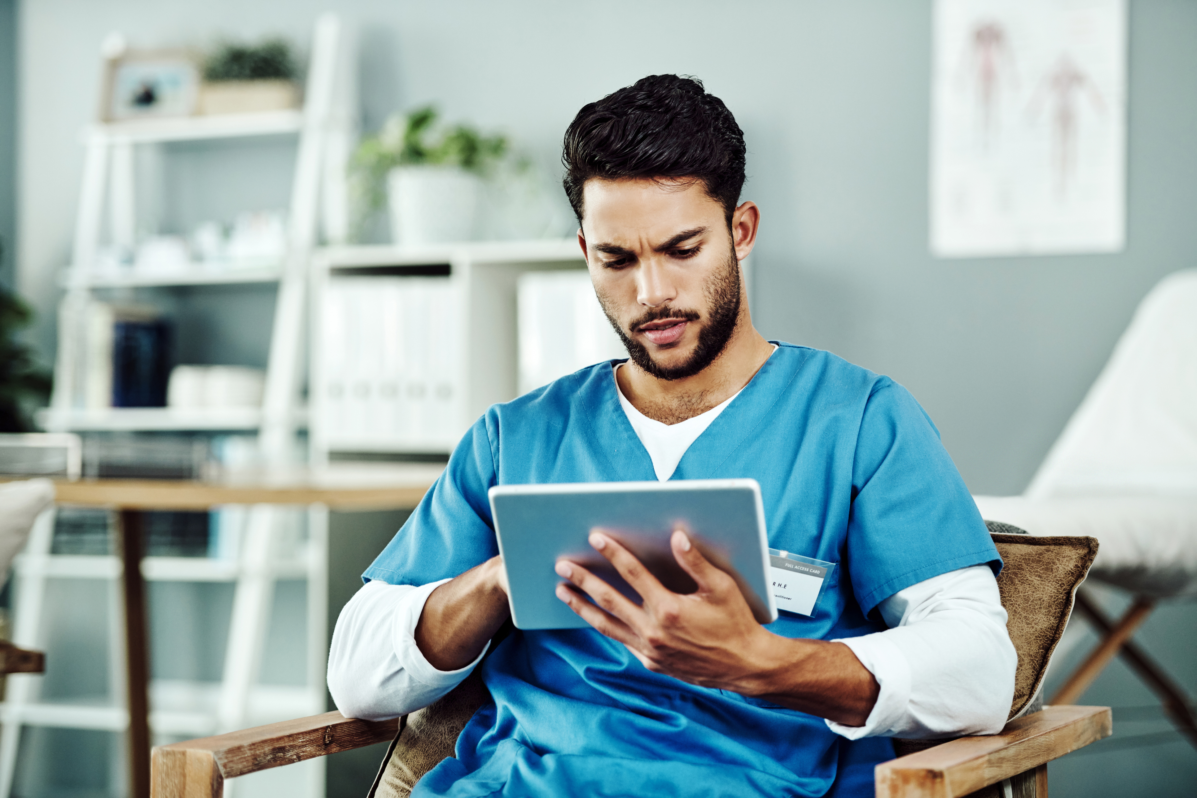 iStock-1179605477 Medical assistant reading on tablet